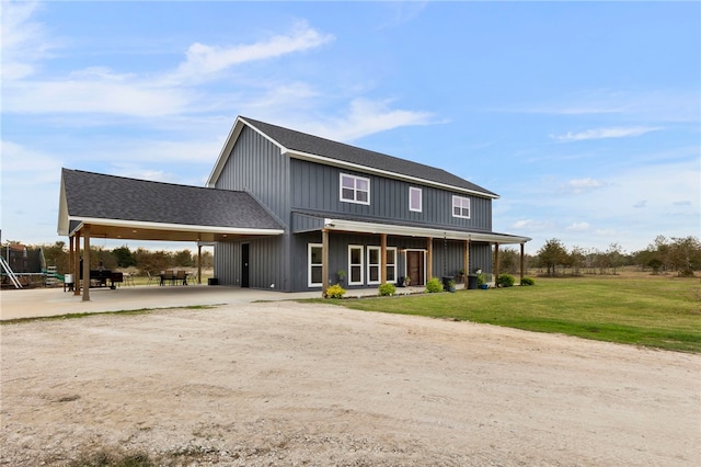 view of front of house with a shingled roof and a front yard