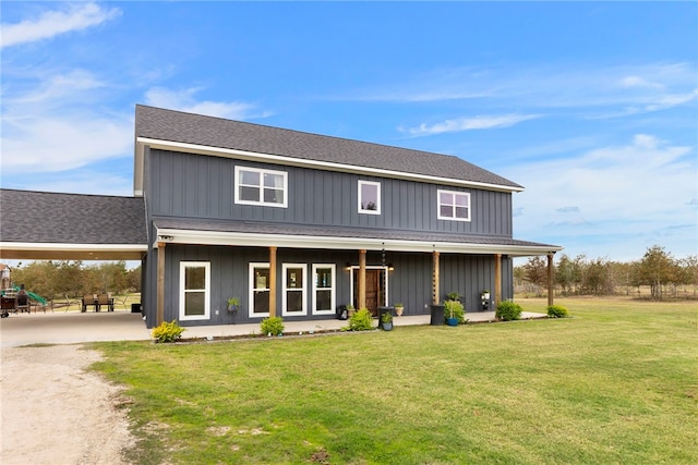 view of front facade with board and batten siding and a front yard