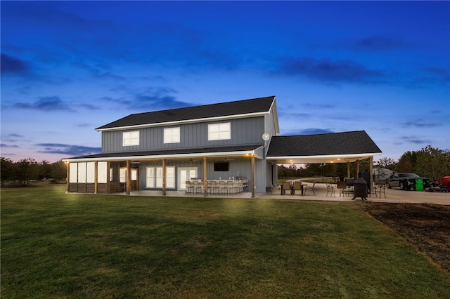 back of house with a yard and a patio