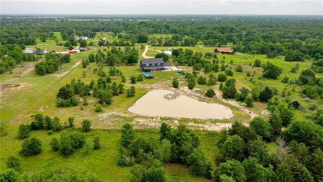 drone / aerial view featuring a rural view and a wooded view