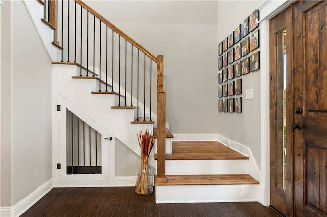 interior space featuring baseboards and wood finished floors