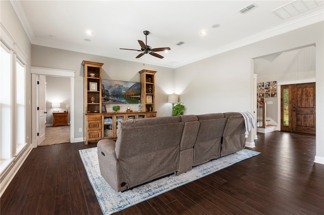 living area featuring stairs, visible vents, dark wood finished floors, and crown molding