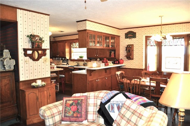 interior space with a textured ceiling, a notable chandelier, and sink