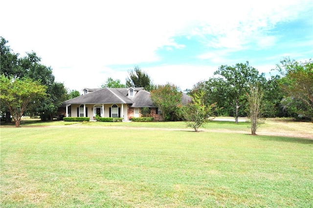 single story home featuring covered porch and a front yard