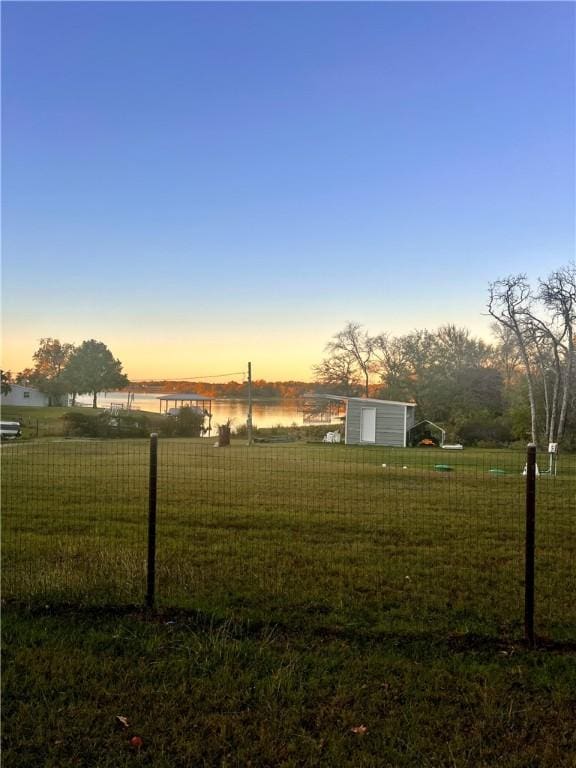 yard at dusk with a water view