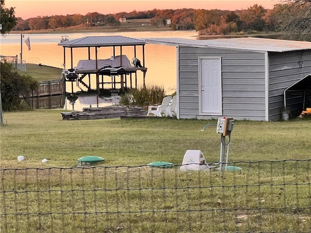 yard at dusk with a water view