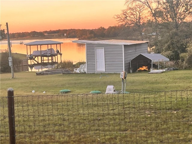 exterior space featuring a yard and a water view