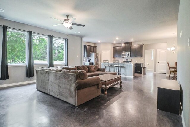 12029 Eagle Ln, North Zulch, TX 77872 - living area featuring healthy amount of natural light, a ceiling fan, finished concrete floors, a chandelier, and recessed lighting
