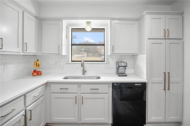 8700 Bent Tree Dr, College Station, TX 77845 - kitchen featuring black dishwasher, a sink, tasteful backsplash, light countertops, and white cabinets