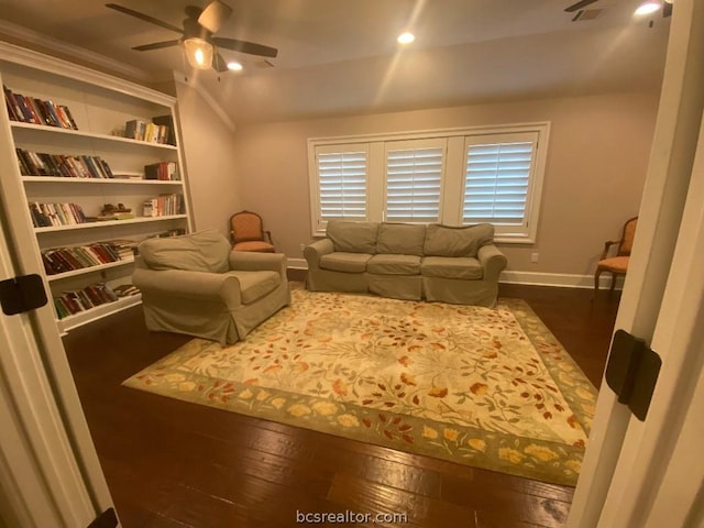 living room featuring ceiling fan and dark hardwood / wood-style flooring