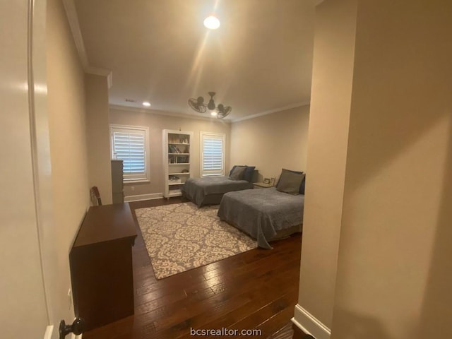 bedroom with dark hardwood / wood-style flooring and ornamental molding