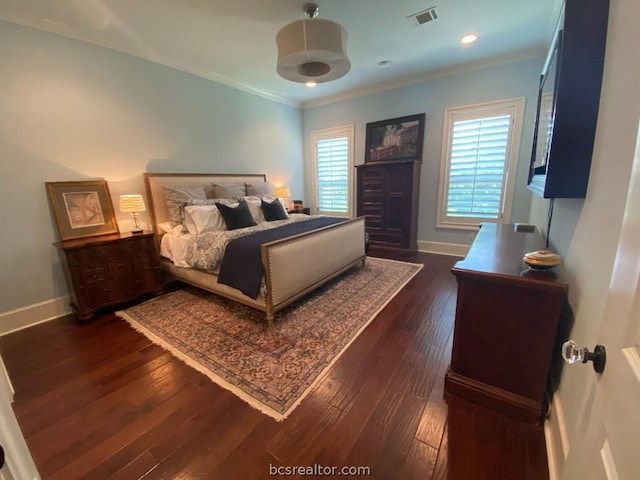 bedroom with crown molding and dark hardwood / wood-style flooring