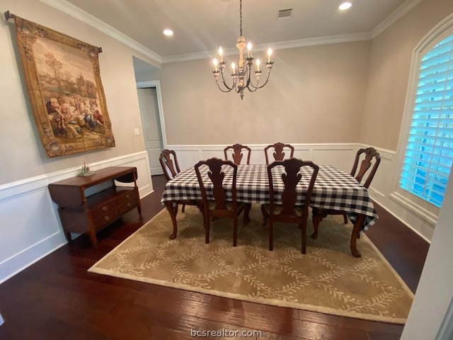 dining area with dark hardwood / wood-style floors, crown molding, and a notable chandelier