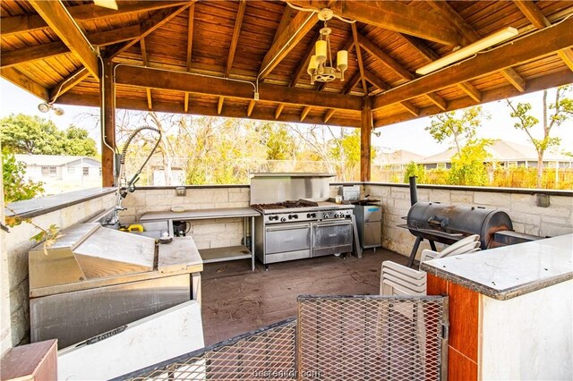 view of patio with a gazebo, grilling area, and exterior kitchen