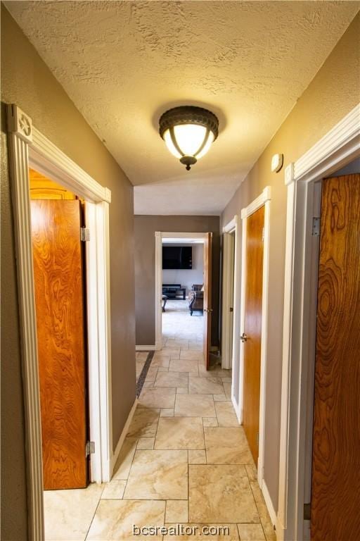 hallway featuring a textured ceiling