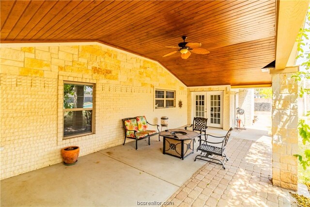 view of patio with french doors, a fire pit, and ceiling fan