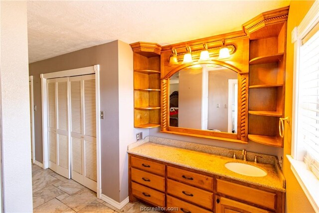 bathroom with vanity and a textured ceiling