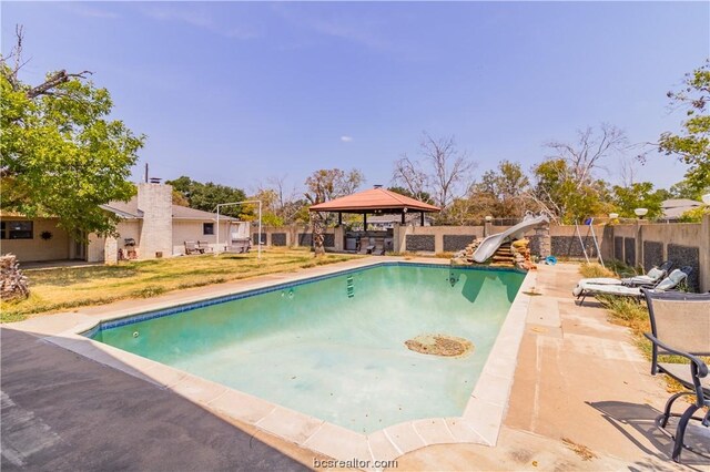 view of swimming pool featuring a gazebo, a water slide, and a patio