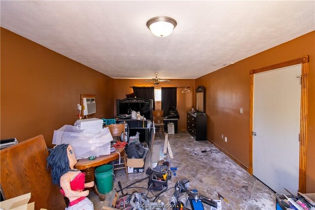 interior space with a wall mounted air conditioner and ceiling fan