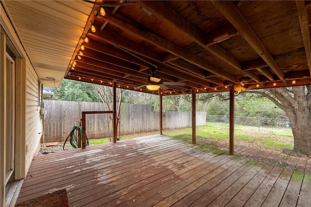 wooden terrace with a fenced backyard and a ceiling fan