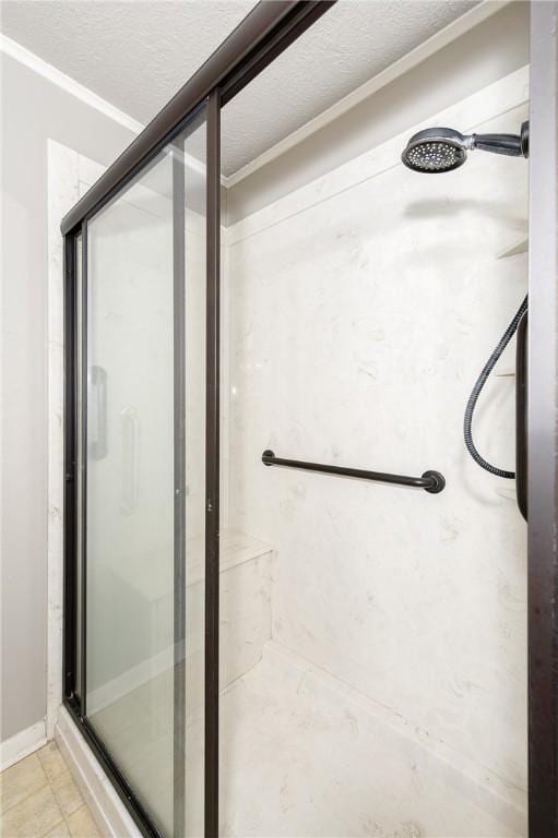 bathroom featuring a shower stall and a textured ceiling