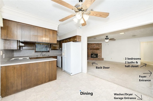 kitchen featuring a peninsula, light countertops, dishwasher, white fridge with ice dispenser, and crown molding