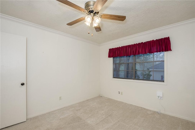 unfurnished room featuring ornamental molding, carpet flooring, a textured ceiling, and a ceiling fan