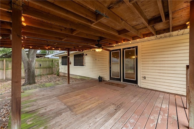 wooden terrace with fence and a ceiling fan