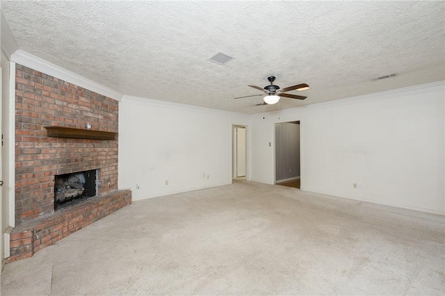 unfurnished living room with ornamental molding, a brick fireplace, and visible vents