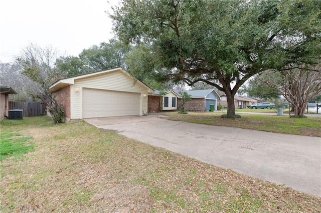 ranch-style home featuring brick siding, central air condition unit, concrete driveway, a garage, and a front lawn