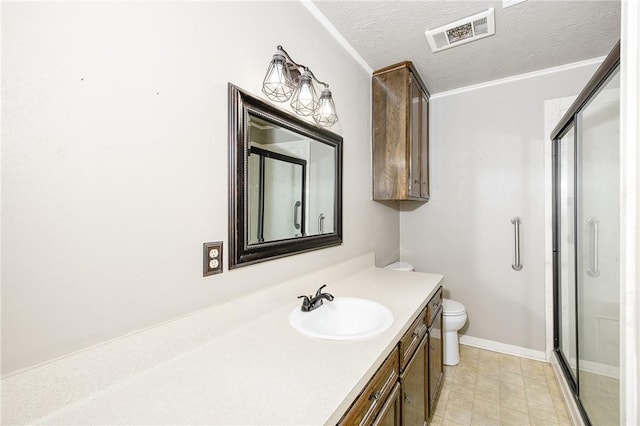 bathroom with a stall shower, visible vents, toilet, a textured ceiling, and vanity