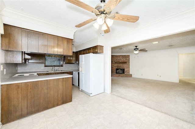 kitchen with white refrigerator with ice dispenser, light countertops, open floor plan, dishwasher, and a peninsula