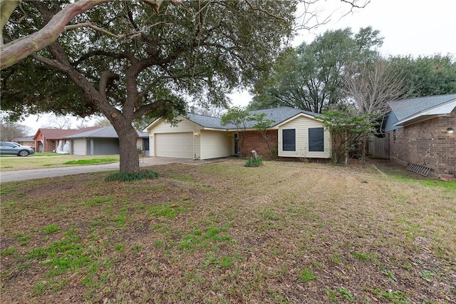 ranch-style house featuring a front yard, brick siding, driveway, and an attached garage