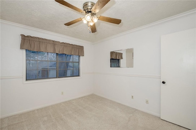 spare room with ornamental molding, light carpet, ceiling fan, and a textured ceiling