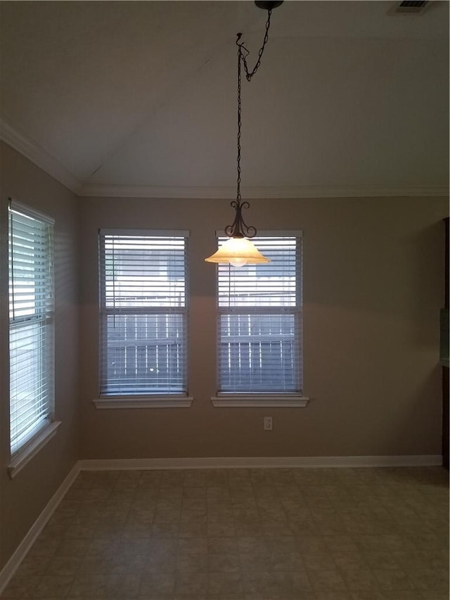 spare room with a healthy amount of sunlight, ornamental molding, vaulted ceiling, and baseboards