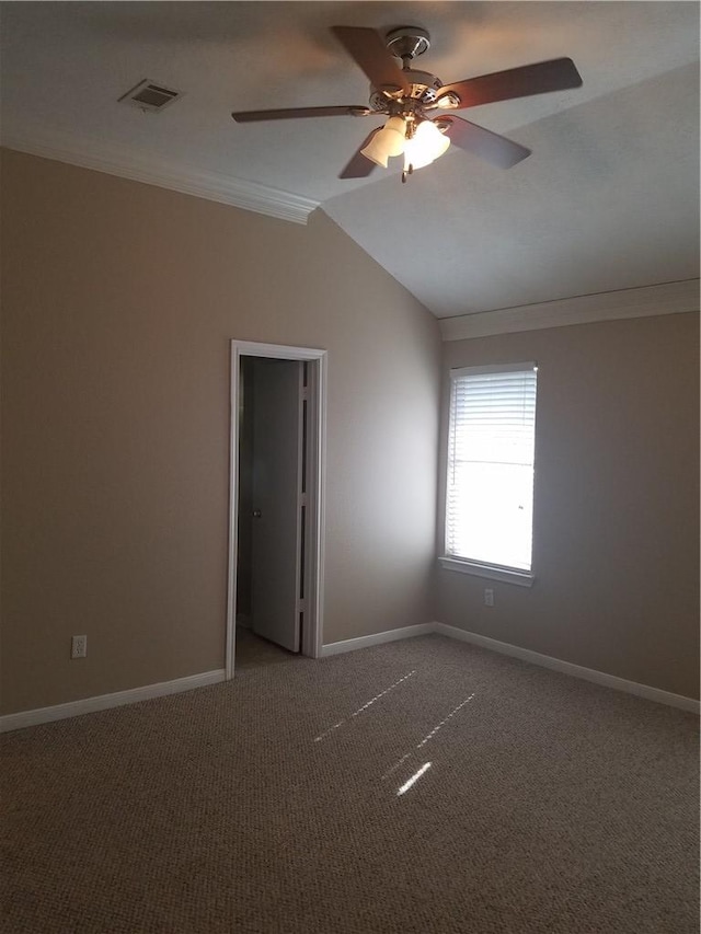 carpeted spare room with baseboards, ornamental molding, and ceiling fan