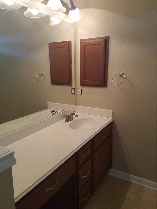 bathroom with vanity and baseboards