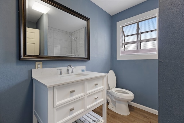 bathroom with hardwood / wood-style floors, vanity, and toilet