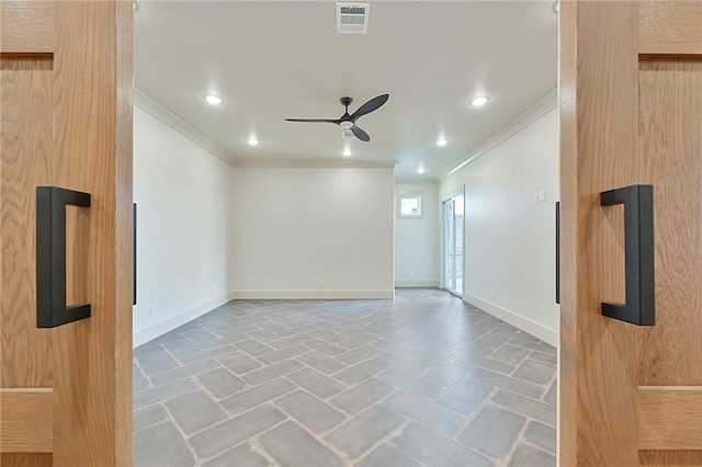 spare room featuring ceiling fan and crown molding