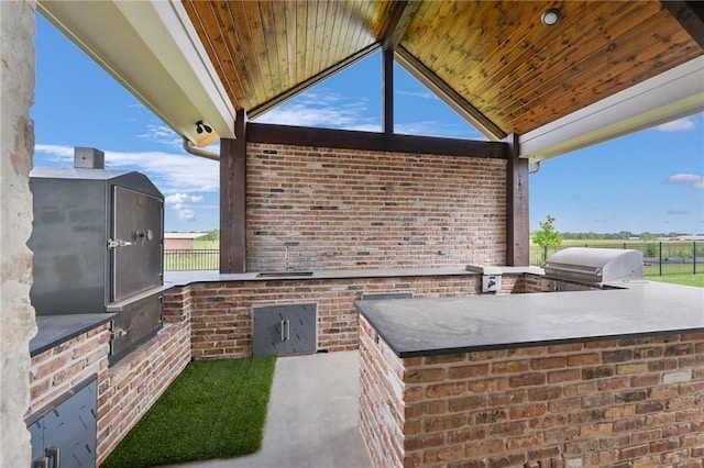 view of patio featuring area for grilling and a grill