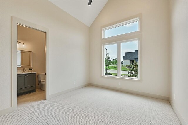 spare room with a healthy amount of sunlight and light colored carpet