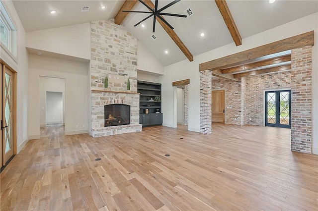 unfurnished living room with french doors, light hardwood / wood-style floors, and high vaulted ceiling