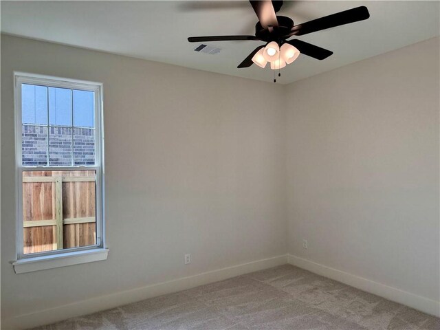 unfurnished room with ceiling fan and light carpet