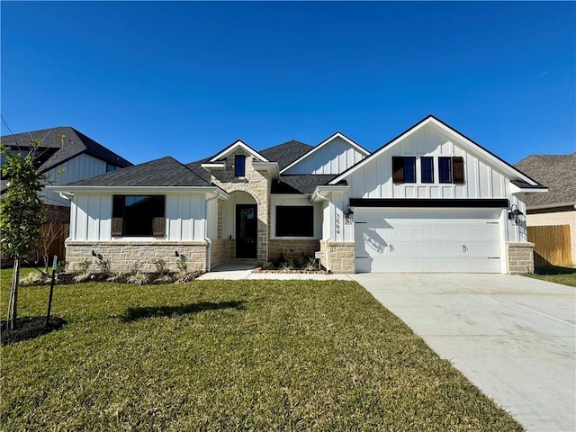 view of front of house featuring a garage and a front lawn