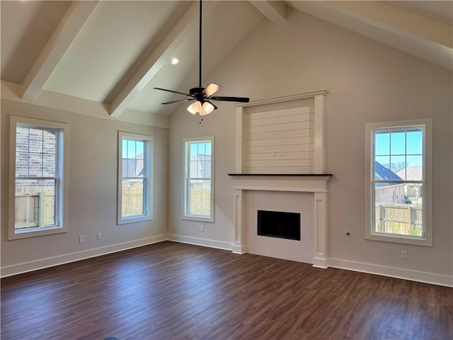 unfurnished living room with vaulted ceiling with beams, ceiling fan, a healthy amount of sunlight, and dark hardwood / wood-style floors