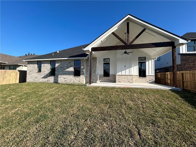 rear view of property with a lawn, ceiling fan, and a patio