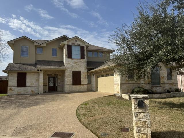 view of front of home with a garage and a front lawn