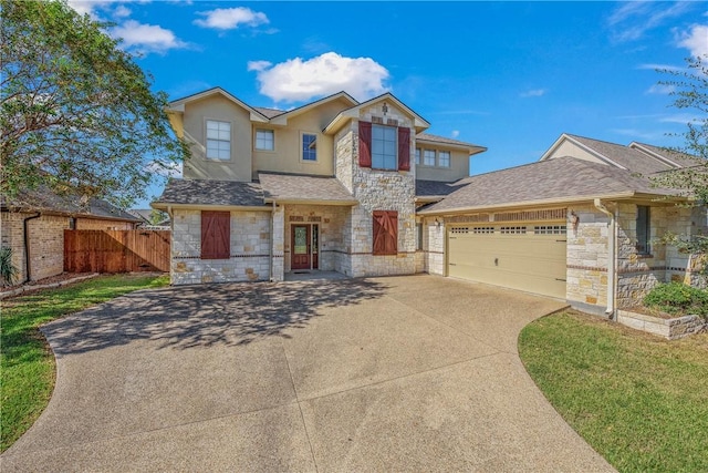 view of front of property featuring stone siding, an attached garage, concrete driveway, and fence