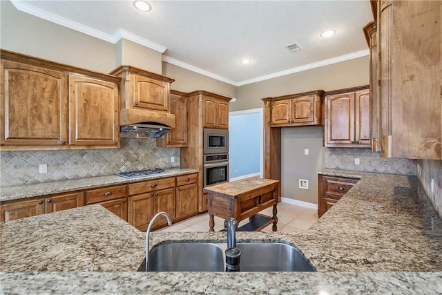 kitchen with light tile patterned floors, light stone countertops, stainless steel appliances, and a sink