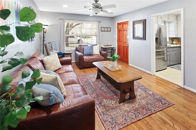 living area featuring recessed lighting, baseboards, light wood-style floors, and ceiling fan